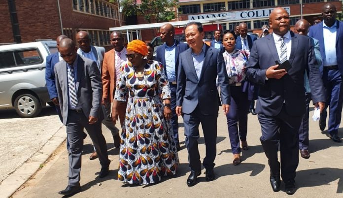Samsung South Africa representatives led by its CEO Sung Yoon walk out of a meeting with Department of Education officials