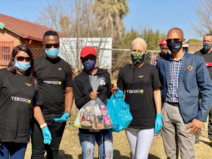 Mama Meet The One cast members holding food parcels to be donated to the needy