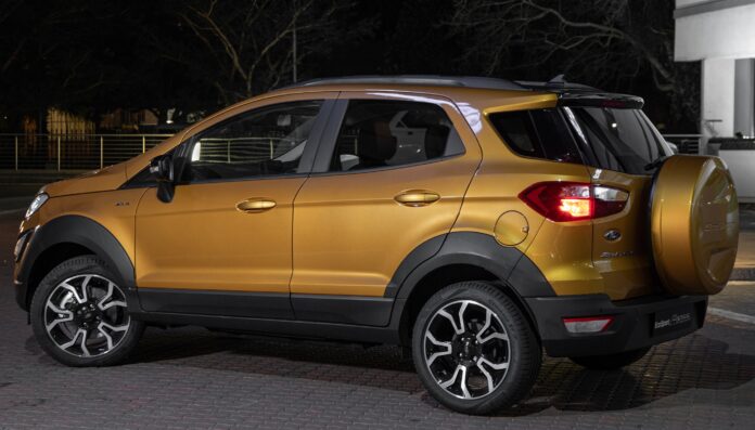 Luxe yellow Ford Ecosport Active parked outside a block of residential apartment