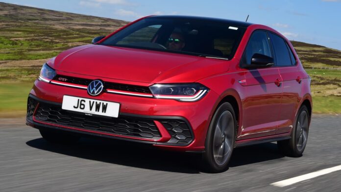 2022 VW Polo GTI parked on a road, besides green and lush lawn
