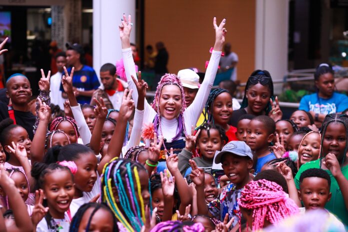 South African musician Sho Madjozi celebrates with hundreds of children the launch of her book at the Mall of Africa in Gauteng.
