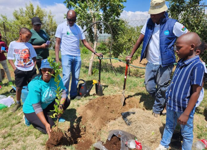 A team of P&G employees teach Soweto learners how to plant trees