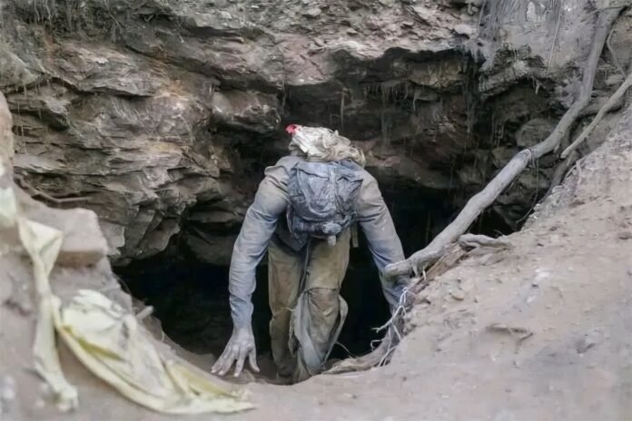 South Africa — Illegal miner emerge from an underground mine shaft