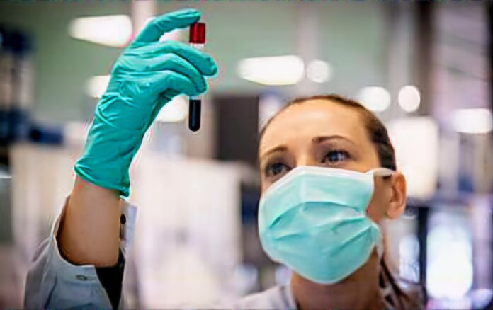 A medical practitioner holding a lab test