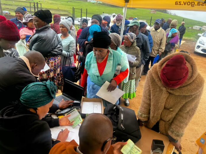 South African elderly queue to receive their SASSA grants.