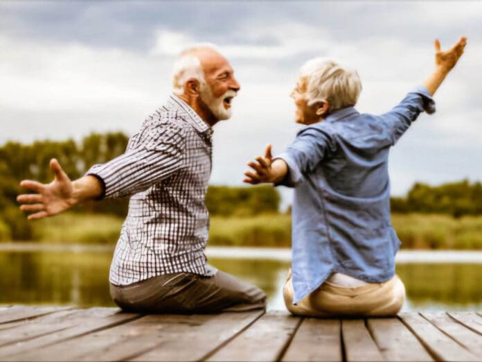 A Finnish elderly couple picnics by a lakeside, embodying trust and nature