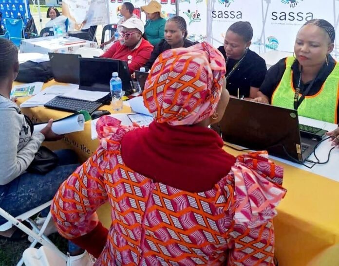 SASSA staff assist grant applicants during a community outreach event in South Africa.