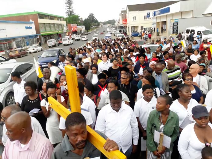 Easter Catholic worshipers carrying a large cross