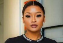 SIU responds to claims linking influencers to corruption probe A portrait of South African influencer and DJ Cyan Boujee, styled in a sleek black outfit with branded strap detailing across the neckline. She wears bold makeup with defined lashes and has her hair neatly tied back. The image is taken indoors with a softly blurred background.