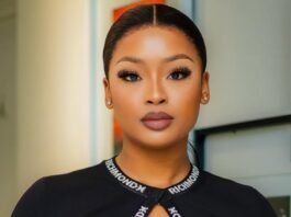 SIU responds to claims linking influencers to corruption probe A portrait of South African influencer and DJ Cyan Boujee, styled in a sleek black outfit with branded strap detailing across the neckline. She wears bold makeup with defined lashes and has her hair neatly tied back. The image is taken indoors with a softly blurred background.