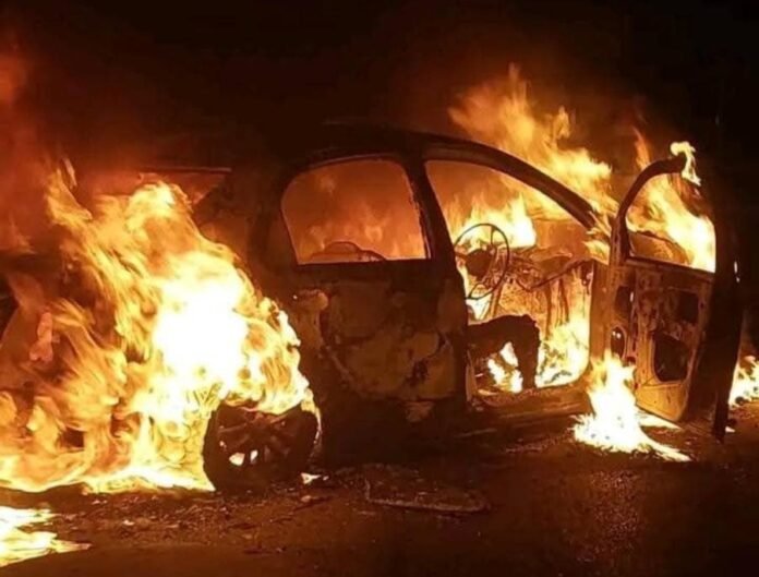Burning e-hailing car outside Maponya Mall at night.