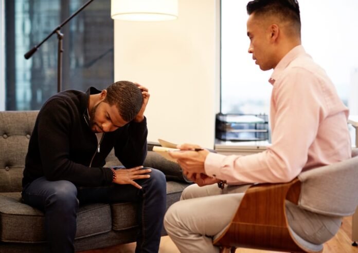 Man in therapy session with male psychologist