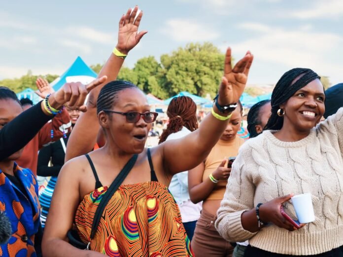 Excited crowd cheering at AfroFlair Mzansi Festival in Soweto.