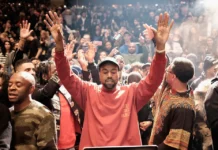 Kanye West South Africa Dec 13 concert cancelled as Ye replaces original promoter Kanye West raising his hands before a cheering crowd.