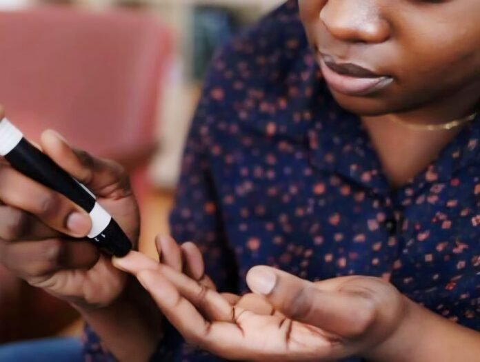 A woman performing a finger-prick blood glucose test.