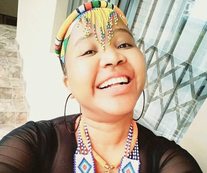 The late Namhla Mtwa, pictured smiling, in beaded traditional attire.