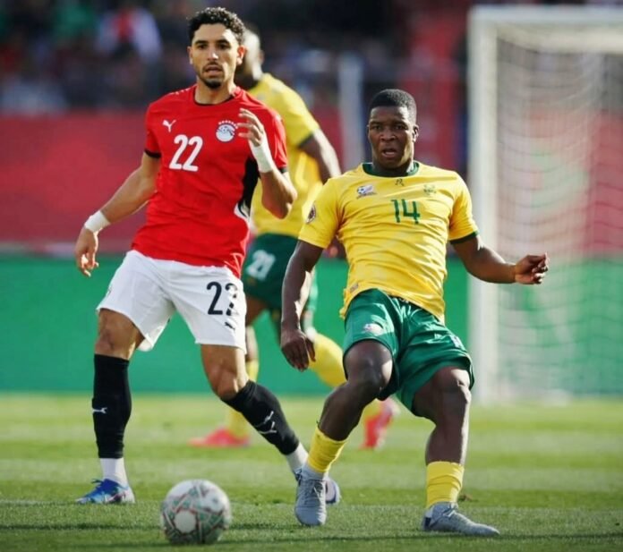 Mohamed Salah battles a South African midfielder in a tense AFCON 2025 clash in Morocco.