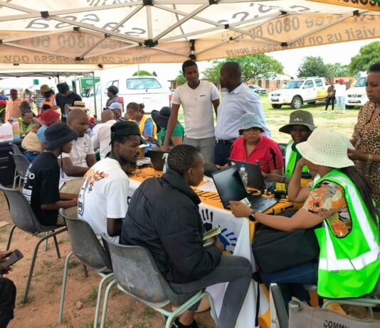 SRD April payments resume — avoid this common delay now SASSA officials assist beneficiaries during an outreach programme where grant updates and verification support are processed.