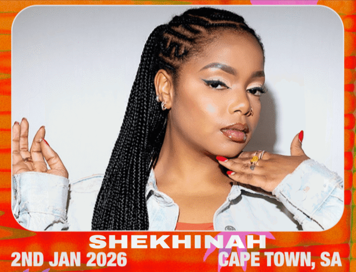 Confident SA R&B singer Shekhinah with neatly braided hair posing in denim jacket.