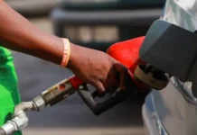 Confirmed January Fuel Prices: Diesel drops R1.50, Petrol Gets a Smaller Cut Petrol attendant refueling a car with a red nozzle at a South African service station; conceptual image for January 2026 fuel price drops.