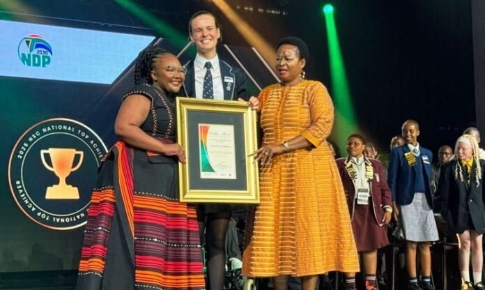 Ranking Top School Districts in South Africa: Minister Siviwe Gwarube presents the 2025 National Top Achiever award to Abigail Kok of York High School.