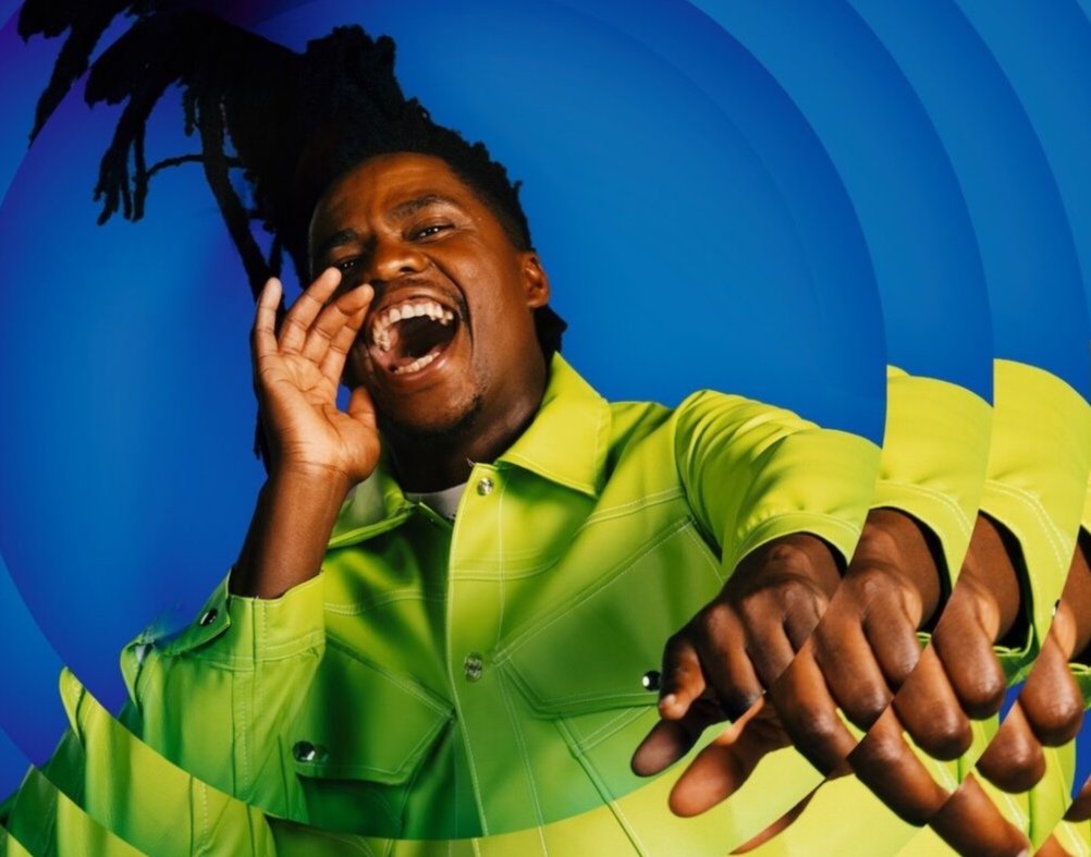 Smash Afrika in a green jacket shouting in a promotional image for Big Brother Mzansi Season 6 “Bazozwa,” symbolising live energy and reality TV drama.