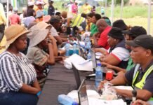 SASSA June 2026 payment dates: last gold card warning SASSA officials assist elderly beneficiaries with gold card migration at outdoor registration table before August deadline.