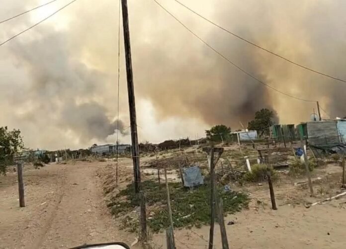 Wildfire smoke over Stanford settlement as fire spreads in Western Cape.