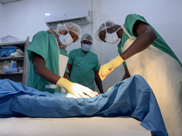 Sudanese medical staff and MSF surgeons performing surgery at Bashayer Teaching Hospital in Khartoum.