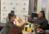 SASSA SRD May 2026 payment dates confirmed: How to check your exact payday SASSA officials assisting applicants with SRD grant verification at a service desk.