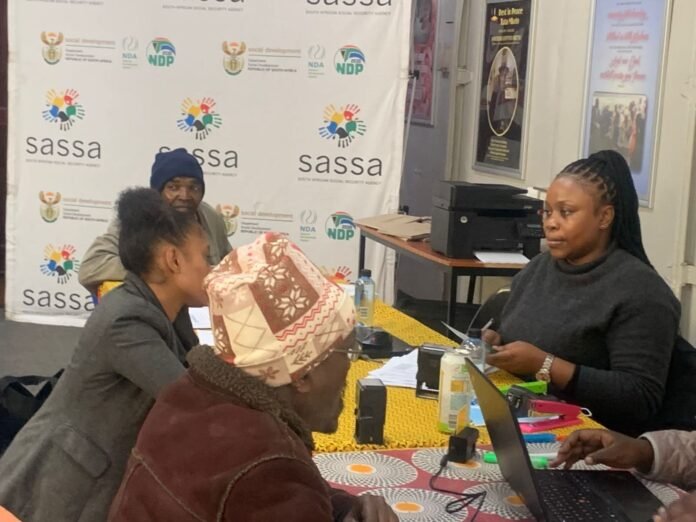 SASSA officials assisting beneficiaries with SRD grant verification in 2026.