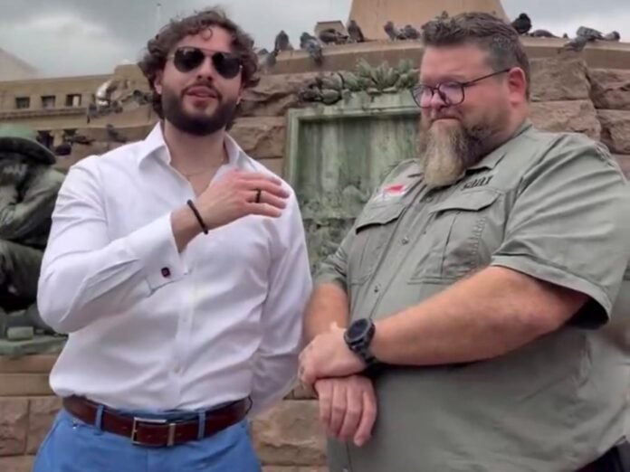 Stefano Forte and Sarel Roets at a South African fountain, visiting amid criticism for promoting foreign propaganda.