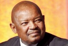 The passing of Mosiuoa “Terror” Lekota: Seven things we won’t forget Portrait of Mosiuoa “Terror” Lekota in a dark pinstriped suit and striped tie, shown in a thoughtful close-up with soft lighting and a warm blurred background.