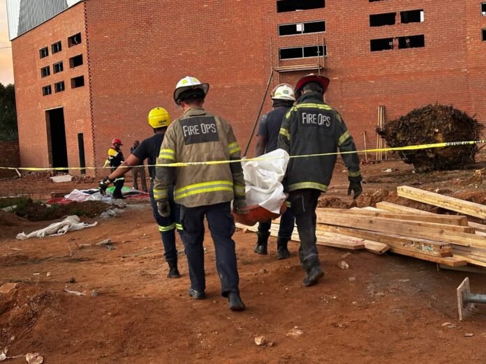 Fire and rescue teams recover a victim from the Ormonde building collapse in Johannesburg after a concrete slab failure at a construction site.