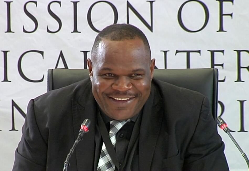 Gauteng Organised Crime Sergeant Fannie Nkosi smiling while testifying about his links to the Big Five cartel and Tshwane tenders.