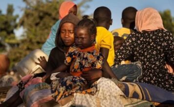 Sudan war: Chemical weapons allegations fuel calls for global probe Sudanese children and families displaced by war sit with belongings, reflecting the humanitarian crisis and impact of conflict on civilians.