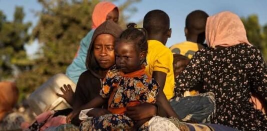 Sudan war: Chemical weapons allegations fuel calls for global probe Sudanese children and families displaced by war sit with belongings, reflecting the humanitarian crisis and impact of conflict on civilians.