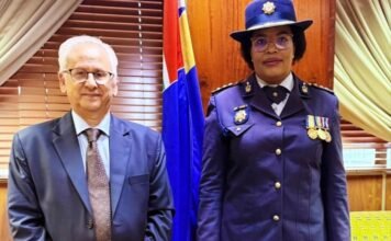 President appoints acting police commissioner as Masemola faces PFMA charges over R360m tender Firoz Cachalia and Acting SAPS National Commissioner Puleng Dimpane stand side by side in formal attire in front of a South African flag.