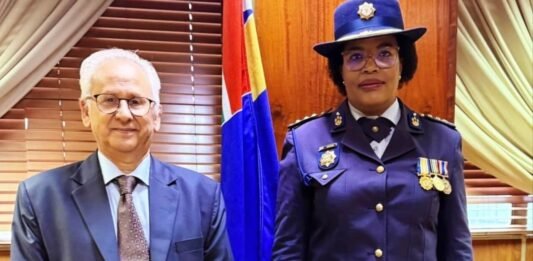 President appoints acting police commissioner as Masemola faces PFMA charges over R360m tender Firoz Cachalia and Acting SAPS National Commissioner Puleng Dimpane stand side by side in formal attire in front of a South African flag.