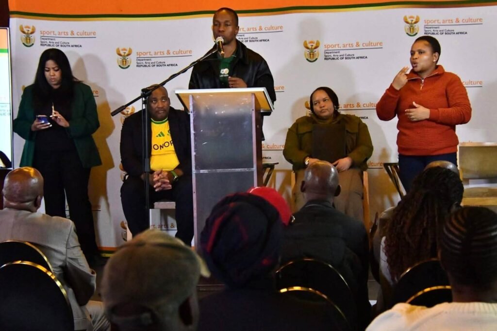 Olympian Akani Simbine addresses the media alongside Minister Gayton McKenzie at the DSAC World Cup 2026 briefing.