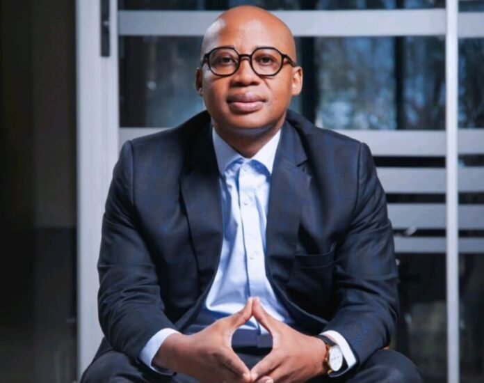 Dr Danny Tong, founder and chairman of InvesTong Group, posing in a professional suit.