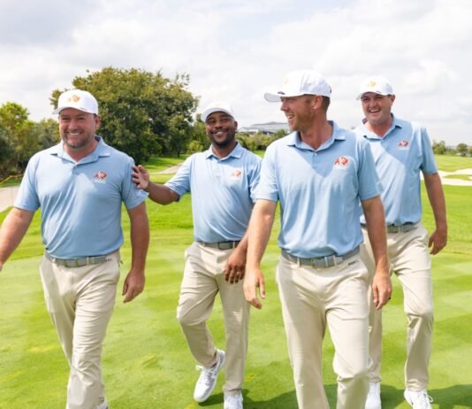 LIV Golf Smash GC rebrands to OKGC, following South Africa’s lead OKGC golfers Graeme McDowell, Harold Varner III, Talor Gooch and Jason Kokrak walk together laughing on a green fairway in matching uniforms.