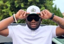 ‘I was just trolling’ – Scooby Nero apologises for RDP claims, admits he ‘didn’t read the room’ Scooby Nero in white polo and aviator sunglasses adjusting a two-tone cap with green brim and crest.
