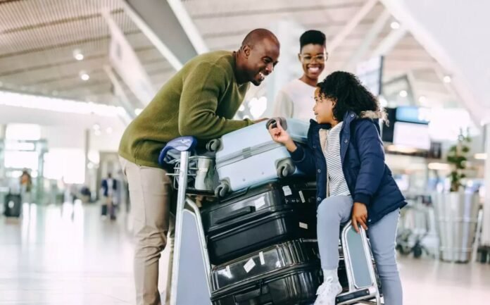 Family with luggage at airport symbolising South Africans returning home after working overseas.