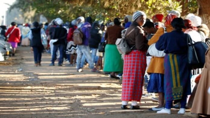 Zimbabweans queue outside a Home Affairs office in Harare to apply for passports.
