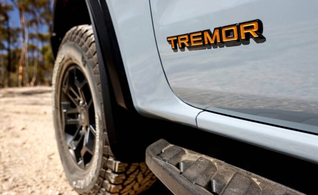 Close-up of the black and orange embossed badge on the 2026 Ford Everest Tremor highlighting its rugged exterior off-road trim.