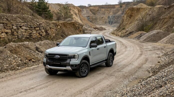A light-grey Ford Ranger Tremor navigating a winding quarry dirt track to demonstrate the platform capability shared with the upcoming 2026 Ford Everest Tremor.