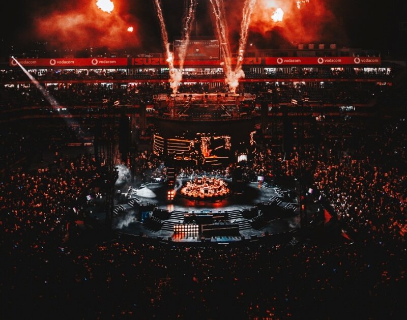 A massive crowd at a sold-out Scorpion Kings Live stadium concert with pyrotechnics and high-end stage production.