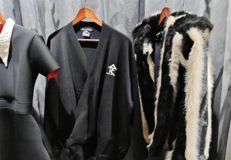 Black-and-white faux fur coat and logo-branded apparel at the Essie Apparel store.
