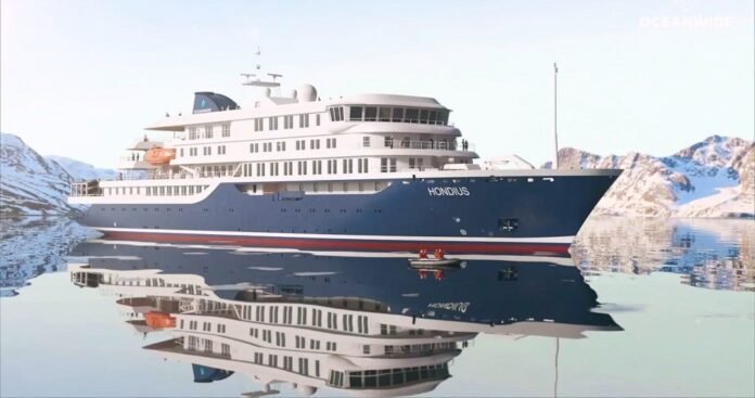 A side profile of the navy and white MV Hondius cruise ship reflecting on calm water, currently central to a deadly hantavirus crisis.